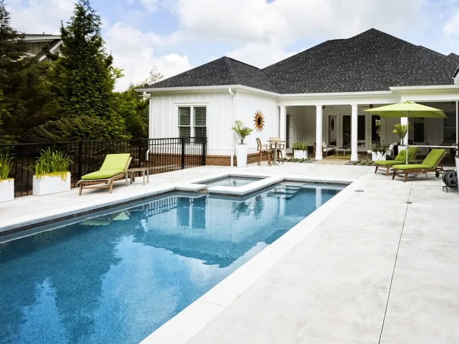 Backyard rectangular pool with house in distance